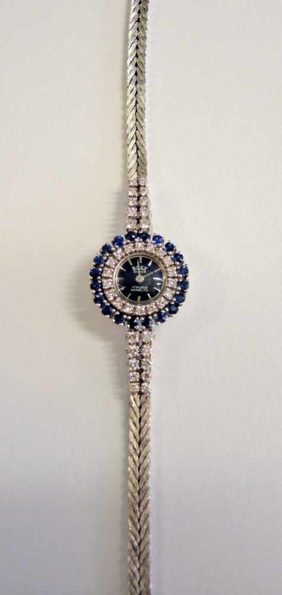Roxy, Damen-Armbanduhr18 K. Weißgold, besetzt mit Diamanten von ca. 0,50 ct. und Saphiren von ca.