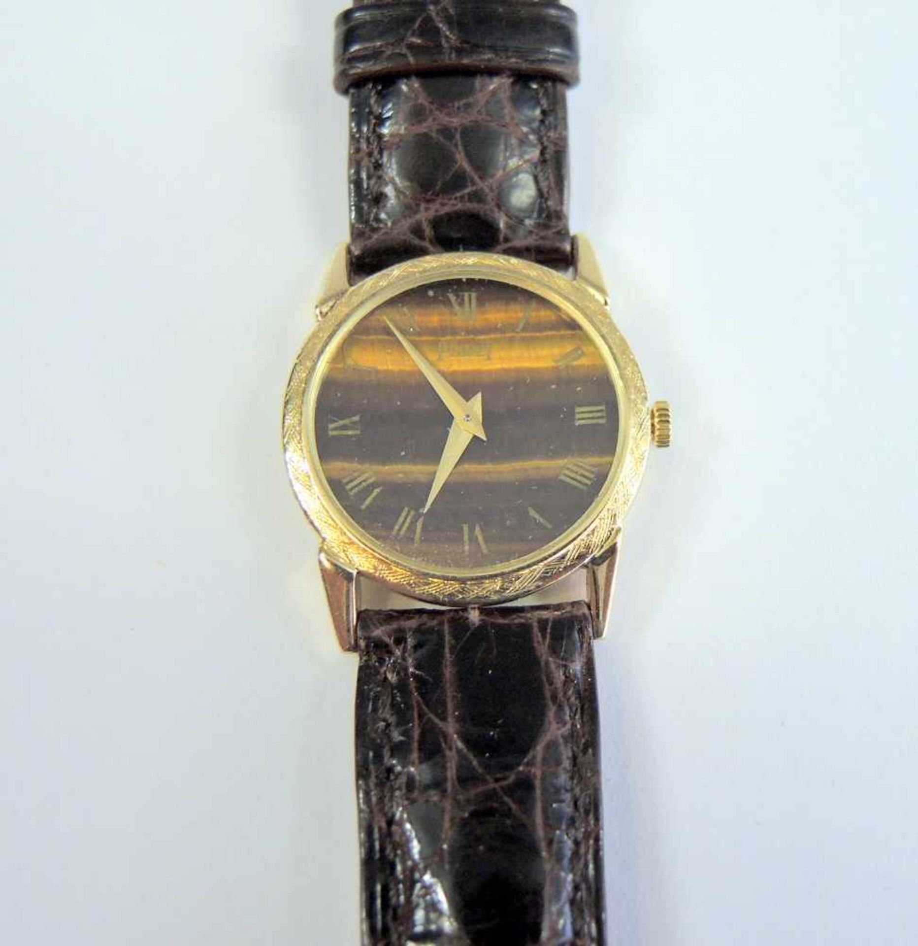 Piaget, Damen-Armbanduhr18 K. Gelbgold, mit braunem Lederband und Tigernaugen-Ziffernblatt braunes