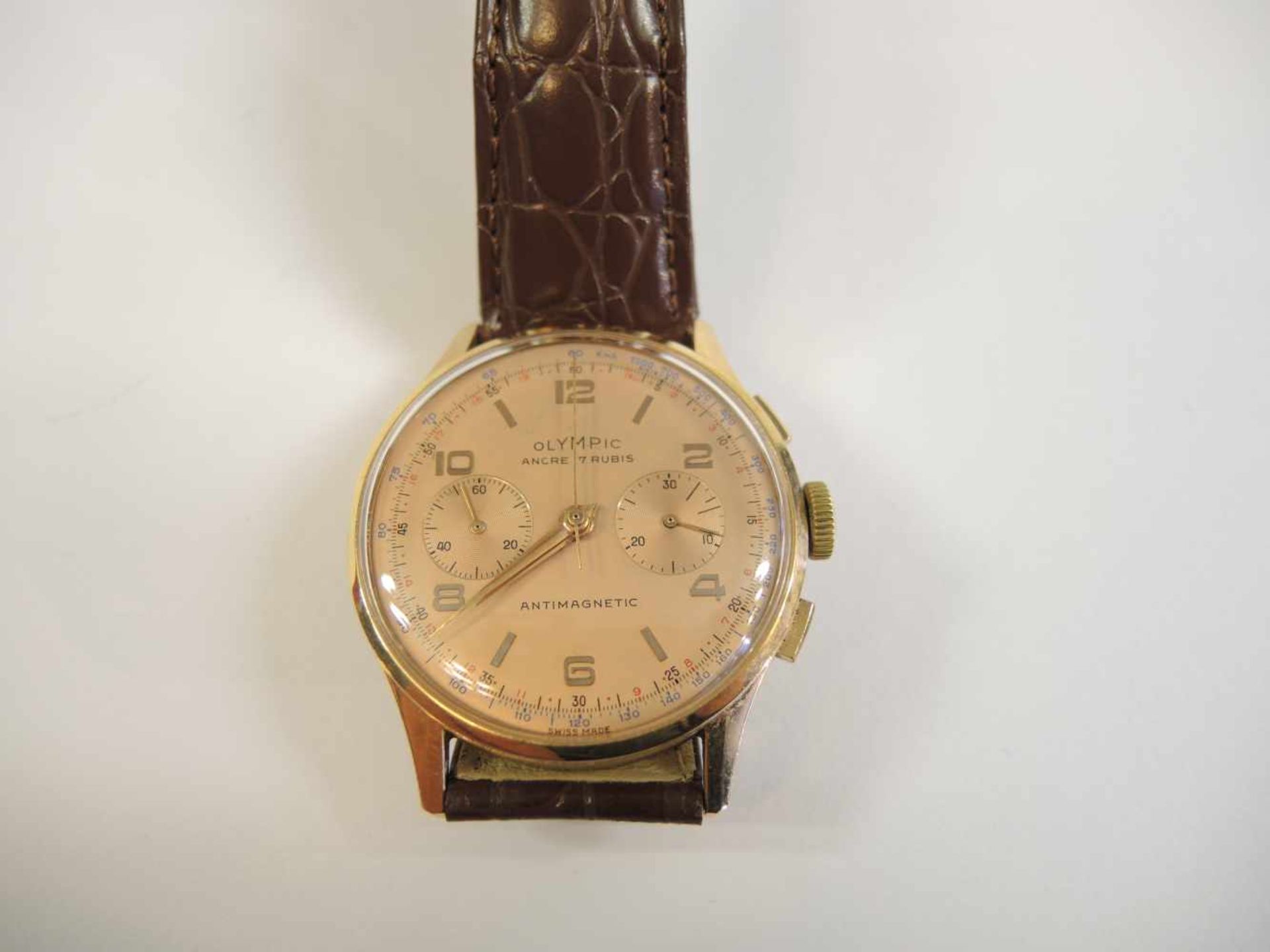 Olympic, Chronograph18 K. Gold, Handaufzug, voll gangbar. In sehr guter Erhaltung. Ø ca. 3,6 cm