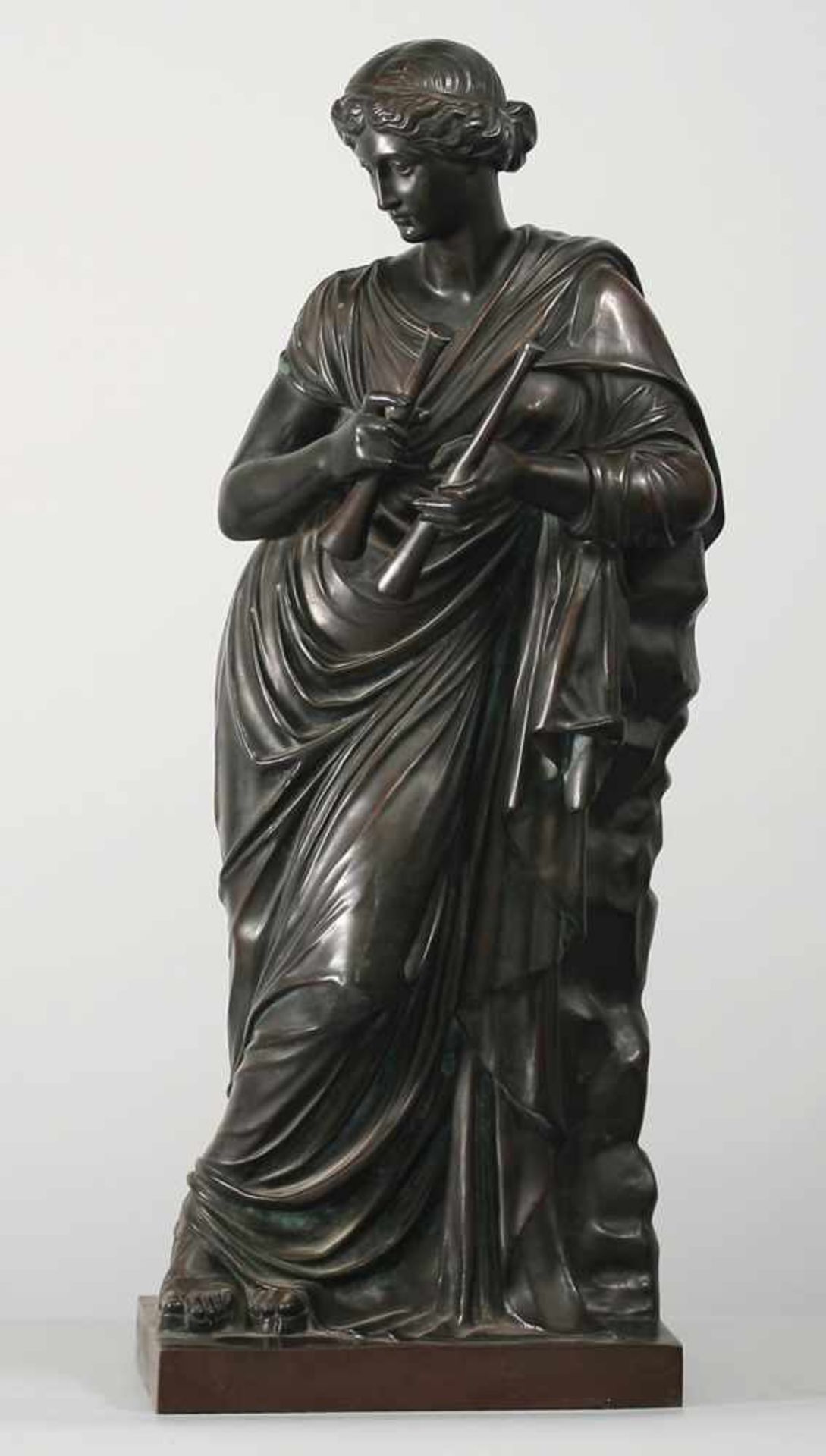 Statue der Euterpe Bronze, patiniert. Auf rechteckiger Plinthe Darstellung der an einen Felsen