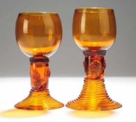 Paar Römer Honigbraunes Glas. Formgeblasen, Abriss. Ansteigender gerippter Hohlfuß, zylindrischer
