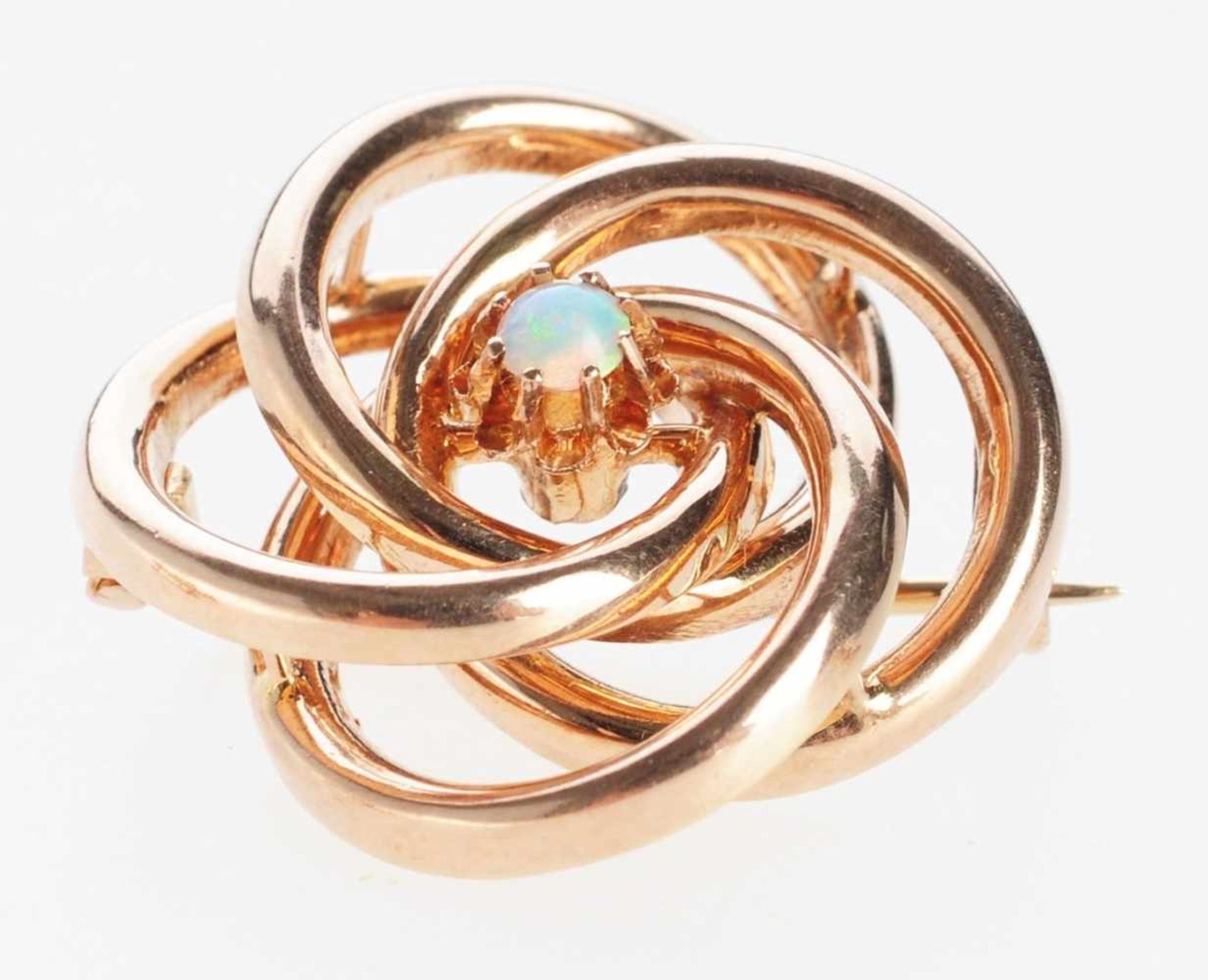Opal-Brosche 585er Roségold. Form aus 4 ineinander gesteckten Ringen. Mittig kleine Blüte mit Opal-