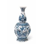 A Berlin faience vase with Delftware style decor Of slightly lopsided octagonal section, decorated