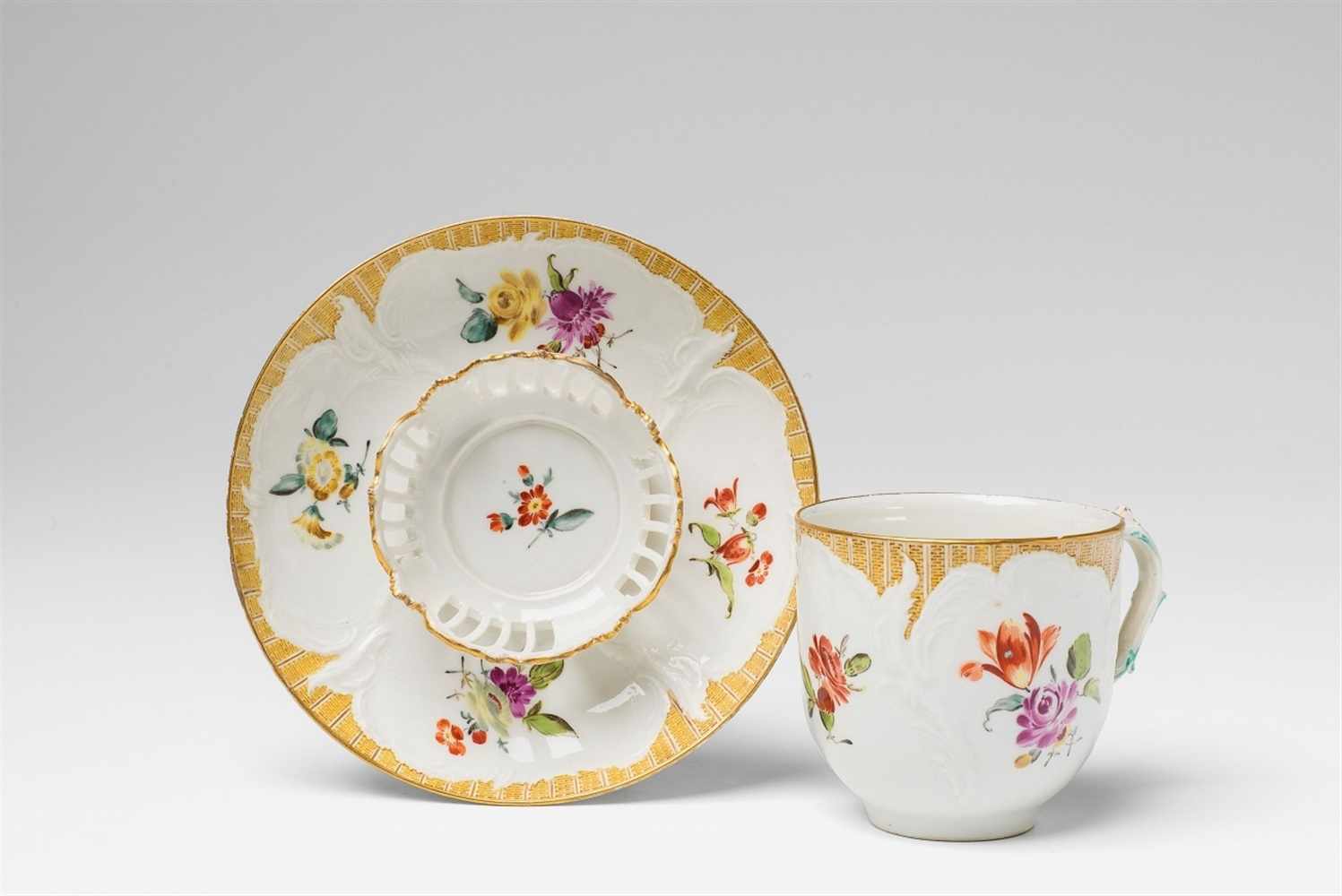 A Berlin KPM porcelain trembleuse with floral decor Model no. 16, with original saucer. Blue sceptre