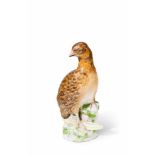 A Berlin KPM porcelain model of a partridge Model no. 163 A. Depicted standing on a rocky base.