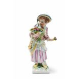 A Berlin KPM porcelain gardener girl with an oval basket Model no. 550. Blue sceptre mark to the