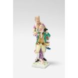 A rare Berlin KPM porcelain "piggyback" group A three-figure miniature group comprising a