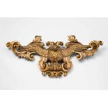 A carved giltwood cartouche with an eagle in flight A dynamic model of a perching eagle with