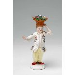 A rare Wegely porcelain figure of a Chinese chef Depicted in contrapposto balancing a basket of