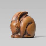 A small boxwood netsuke of a rabbit. 19th centuryCrouching and almost shaped into a ball, head