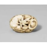 A flat oval ivory ryûsa manjû of mushrooms, pine cones and leaves. Mid-19th centuryCarved with an