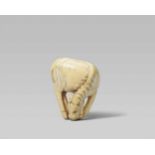 A small ivory netsuke of a grazing horse. Late 18th/early 19th centuryStanding with all four