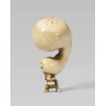 A stag antler netsuke of a sumô wrestler with a huge gourd. 19th centuryStanding in balance with