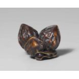 A large stained wood netsuke of three walnuts and two soy beans, by Unkoku. Late 19th centuryThree