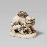 A very good ivory netsuke of two bushy-haired shishi. Mid-19th centuryStanding on an oval flat base,