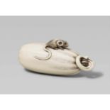An ivory netsuke of a pumpkin with a small rat. First half 19th centuryA rat sits on a large
