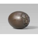 An unusual and rare bronze netsuke of a tengu no tamago. Early 19th centuryThe crow-headed tengu