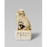 An elegant ivory seal netsuke of a kirin. 19th centurySeated on its haunches with one foreleg