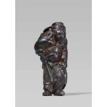 A wood netsuke of Shôki, by Tomochika. Early 19th centuryStanding with one leg slightly raised,