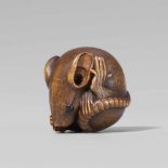 An Ise school boxwood netsuke of a rat rolled into a ball, by Masakiyo. First half 20th