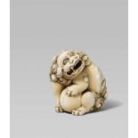 An ivory netsuke of a mighty shishi. Early 19th centurySeated on its haunches, the head tilted and