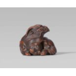 A very fine Nagoya school wood netsuke of a kirin, by Ikkan. Mid-19th centuryReclining, the head