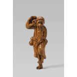 A boxwood netsuke of a bearded Tekkai Sennin. Late 18th/early 19th centuryThe long-haired and