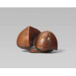 A boxwood netsuke of three chestnuts. Early 19th centuryOne upright and one horizontally placed