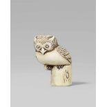 A rare walrus tusk netsuke of an owl. 19th centuryPerched on a short tree trunk with a short