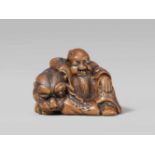 A charming boxwood netsuke possibly of Bunkan Zenshi. Early 19th centurySleeping and seated at