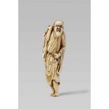 An ivory netsuke of a bearded sennin. Early 19th centuryThe long-haired and bearded sennin stands