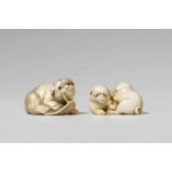 Two ivory netsuke of dogs. 19th/20th centurya) A piebald puppy biting the thong of a discarded straw