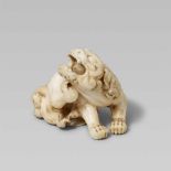 A fine very small ivory netsuke of a shishi. Mid-19th centurySeated, turned to the right and