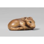 A boxwood netsuke of a large rat. Second half 19th centurySitting, the tail slung around its body,