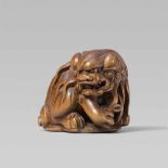 A good boxwood netsuke of a shishi, by Masamitsu. Mid-19th centurySeated on its tail which forms a