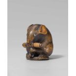 A large boxwood netsuke of a rat with a scroll, by Shigemasa. Mid-19th centurySitting on its tail, a