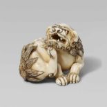 A good ivory netsuke of a shishi. Early 19th centurySeated with forepaws placed close together,