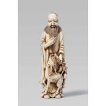 A fine ivory netsuke of Jurôjin. Early 19th centuryThe god stands stroking his long beard and