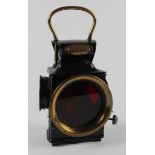 Powell & Hanmer brass & black laquered lamp, no. 515, with red coloured glass, total height 24cm
