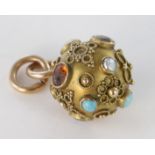 Yellow metal (tests 9ct) Ball pendant set with semi-precious stones weight 2.6g