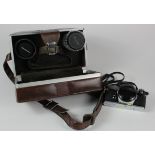 Olympus OM-1 camera, with instructions, additional lenses, etc., all contained in a leather carrying