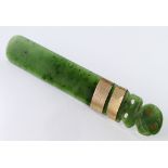 New Zealand interest. A carved green stone (Jade?) letter opener with two gold bands (tests as ...),