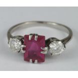 Ladies Palladium Ruby and Diamond three stone ring with an oblong shaped ruby flanked by two 0.