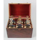 Walnut vaneered box with curved lid, containing six gilt decorated glass bottles (one with