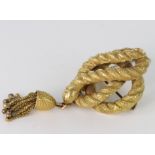 Yellow metal (tests 18ct) Rope knot Brooch with bell tassle adornment and safety chain weight 22.0g