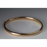 Yellow metal bangle (tests as 14ct) inscribed inside "May From Jo Christmas 1910". Approx 21.4g