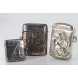 Three silver vesta cases, depicting a golfer, a griffin & two figures on horses, all stamped '