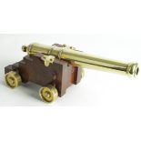 Brass Cannon, mounted on wooden carriage with brass wheels. A fine quality replica of the HMS