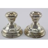 Two silver dwarf candlesticks, both loaded, one dented. Hallmarked Birmingham, 1938