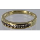 18ct yellow gold diamond channel set half eternity ring, size P, weight 4.4g.